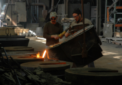 Clarksville Foundry employees pour molten iron into a mold.
